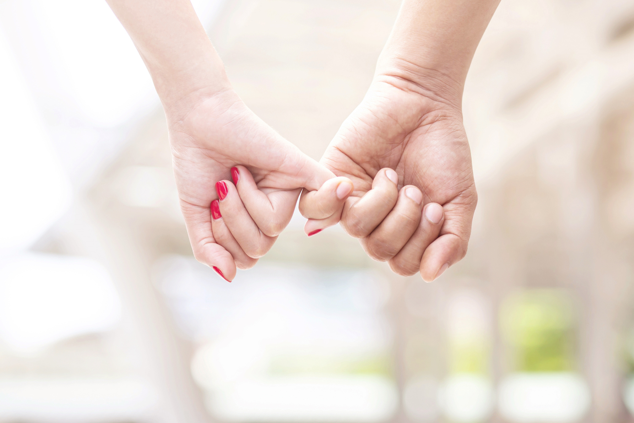 Couple's Pinky Fingers Clasped Together